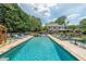 Beautiful backyard swimming pool and lounge area, surrounded by trees offering a private retreat at 4135 Creekwood Dr, Cumming, GA 30041