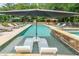 Backyard pool and spa area featuring loungers, a large umbrella and a covered cabana at 4135 Creekwood Dr, Cumming, GA 30041