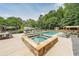 Backyard oasis featuring a large pool, hot tub, lounging area, and well-maintained landscaping at 4135 Creekwood Dr, Cumming, GA 30041
