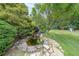 Serene backyard water feature, including a small pond with statues and lush landscaping at 4135 Creekwood Dr, Cumming, GA 30041
