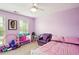 Bright bedroom with pink walls, white trim, ceiling fan, and a playful decor at 4549 Clarks Creek Ter, Ellenwood, GA 30294