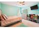 Bedroom features light blue walls, modern dresser, a mounted TV, and organized shoe storage at 4549 Clarks Creek Ter, Ellenwood, GA 30294