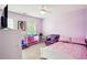 Bright bedroom with pink walls, white trim, ceiling fan, and a playful decor at 4549 Clarks Creek Ter, Ellenwood, GA 30294