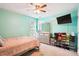 Bedroom features light blue walls, modern dresser, a mounted TV, and organized shoe storage at 4549 Clarks Creek Ter, Ellenwood, GA 30294