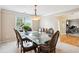 Elegant dining room with large windows, chandelier and a spacious layout at 4549 Clarks Creek Ter, Ellenwood, GA 30294