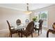 Formal dining room with elegant chandelier and large window offering natural light at 4549 Clarks Creek Ter, Ellenwood, GA 30294