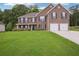 Charming two-story brick home with a well-manicured lawn and attached two-car garage at 4549 Clarks Creek Ter, Ellenwood, GA 30294