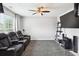 Media room featuring recliner seating, tray ceiling with ceiling fan and a large screen TV at 4549 Clarks Creek Ter, Ellenwood, GA 30294
