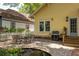 Charming backyard with a patio, pond, grill and white picket fence, ideal for entertaining and outdoor dining at 1290 Mclendon Ne Ave, Atlanta, GA 30307