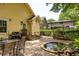 Private backyard featuring a brick patio, outdoor dining area, pond, and lush landscaping at 1290 Mclendon Ne Ave, Atlanta, GA 30307