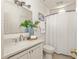 Well-lit bathroom featuring a clean sink, toilet, and shower with a white shower curtain at 1290 Mclendon Ne Ave, Atlanta, GA 30307