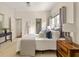 Bright bedroom with bed, two closets, and a wooden nightstand; doorway to bathroom at 1290 Mclendon Ne Ave, Atlanta, GA 30307