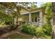 Charming home featuring a welcoming front porch, stone columns, and beautiful landscaping at 1290 Mclendon Ne Ave, Atlanta, GA 30307