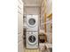 Efficient laundry area with stacked washer and dryer and ample storage shelving at 1290 Mclendon Ne Ave, Atlanta, GA 30307