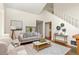 Open-concept living room with high ceilings, stairs, modern decor, and hardwood floors at 1290 Mclendon Ne Ave, Atlanta, GA 30307