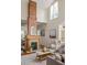 Bright living room featuring a brick fireplace, high ceilings, wood floors, and modern decor at 1290 Mclendon Ne Ave, Atlanta, GA 30307