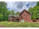 Brick house featuring a back deck, stairs, and a two-car garage at 15 Walnut Ridge Way, Covington, GA 30014
