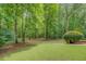 Large backyard with green lawn and mature trees, offering privacy and space at 15 Walnut Ridge Way, Covington, GA 30014