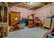 Unfinished basement area showcasing pink insulated walls, storage boxes and exposed ceiling features at 15 Walnut Ridge Way, Covington, GA 30014