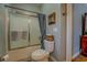 Full bathroom with a shower/tub combo with sliding glass doors and a basket sitting on top of the toilet at 15 Walnut Ridge Way, Covington, GA 30014