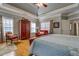 Spacious bedroom featuring a tray ceiling, hardwood floors, and a sitting area at 15 Walnut Ridge Way, Covington, GA 30014