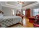 Spacious bedroom featuring a tray ceiling, hardwood floors, and a sitting area at 15 Walnut Ridge Way, Covington, GA 30014