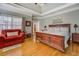 Bright bedroom with a hardwood floor, with a trey ceiling, and a red chair at 15 Walnut Ridge Way, Covington, GA 30014