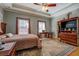 Primary bedroom with a large area rug, hardwood flooring, and trey ceiling at 15 Walnut Ridge Way, Covington, GA 30014