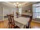 Elegant dining room with chandelier, large table, and hardwood floors at 15 Walnut Ridge Way, Covington, GA 30014