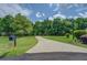 Long paved driveway leading to a beautiful home surrounded by mature trees at 15 Walnut Ridge Way, Covington, GA 30014