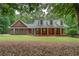 Charming brick home with a welcoming front porch and well-manicured lawn at 15 Walnut Ridge Way, Covington, GA 30014