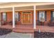 Welcoming front porch with brick flooring and column supports at 15 Walnut Ridge Way, Covington, GA 30014