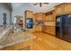 Elegant kitchen showcasing wooden cabinetry, granite countertops, and modern appliances, with great layout at 15 Walnut Ridge Way, Covington, GA 30014