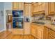 Well-appointed kitchen featuring modern built-in appliances and wooden cabinetry at 15 Walnut Ridge Way, Covington, GA 30014