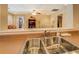 Bright kitchen area with double sink and view to a living area, offering an open-concept feel at 15 Walnut Ridge Way, Covington, GA 30014