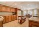 Traditional kitchen boasts wooden cabinetry, tile floor, and an inviting breakfast nook with lots of natural light at 15 Walnut Ridge Way, Covington, GA 30014