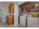 Laundry room with washer, dryer, sink, and built-in shelving at 15 Walnut Ridge Way, Covington, GA 30014