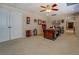 Spacious home office with large desk, carpet floor, and an elegant chair near to storage closets at 15 Walnut Ridge Way, Covington, GA 30014