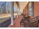 Inviting brick front porch with rocking chairs and ample seating area at 15 Walnut Ridge Way, Covington, GA 30014