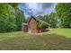 Stunning view of the home's rear exterior, showcasing deck and lush landscaping at 15 Walnut Ridge Way, Covington, GA 30014