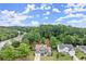 An aerial view showing the house surrounded by trees in a neighborhood at 214 Crestmont Way, Canton, GA 30114