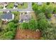 An aerial view of a house with a well-maintained yard, trees, a patio, and a garden at 214 Crestmont Way, Canton, GA 30114