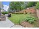A well-maintained backyard featuring a patio, grill, and tiered landscaping, perfect for outdoor enjoyment at 214 Crestmont Way, Canton, GA 30114