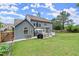 A large backyard with a well-maintained lawn and a patio area with outdoor furniture at 214 Crestmont Way, Canton, GA 30114