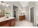Elegant bathroom with double sinks, a soaking tub, a glass shower, and a window overlooking the backyard at 214 Crestmont Way, Canton, GA 30114