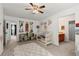 A cozy bedroom with a ceiling fan, artwork, and a crib with a cute rug, creating a warm and inviting space at 214 Crestmont Way, Canton, GA 30114