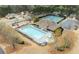 Aerial view showcases a community pool, tennis courts, playground, and surrounding residential area at 214 Crestmont Way, Canton, GA 30114
