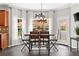Dining nook with large windows, hardwood floors, decorative hanging chandelier and white curtains at 214 Crestmont Way, Canton, GA 30114