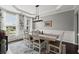 Bright dining room with wainscoting, modern chandelier, and a rustic wooden table at 214 Crestmont Way, Canton, GA 30114