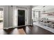 Inviting entryway with a black door, dark hardwood floors, and an adjacent dining room at 214 Crestmont Way, Canton, GA 30114